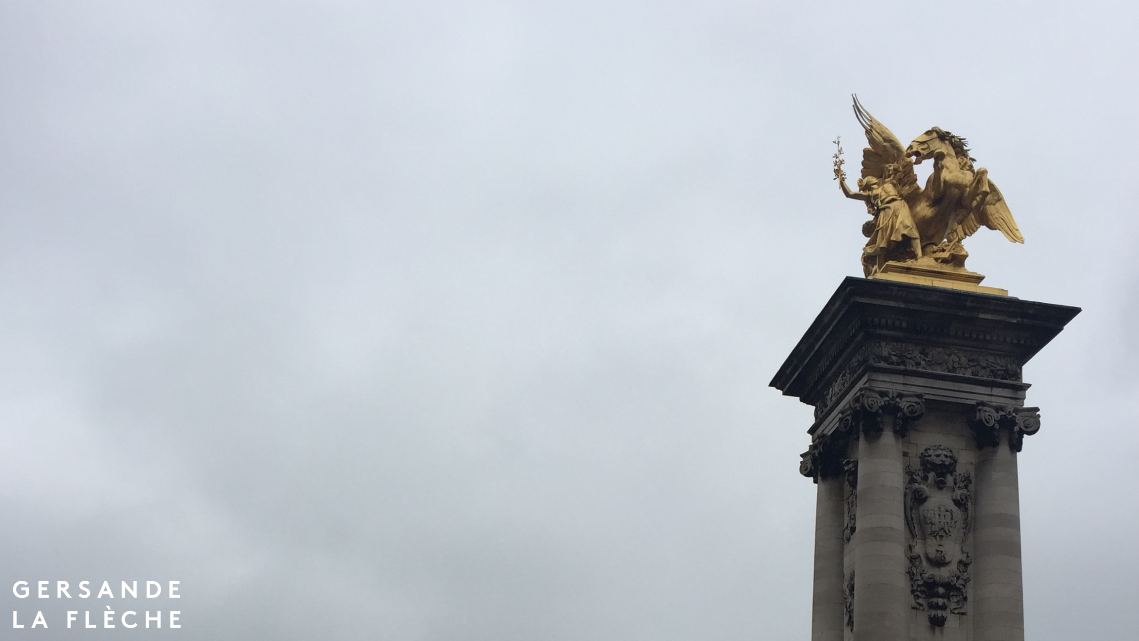 A picture of one of the statues from Pont de la Concorde set against the grey November sky.