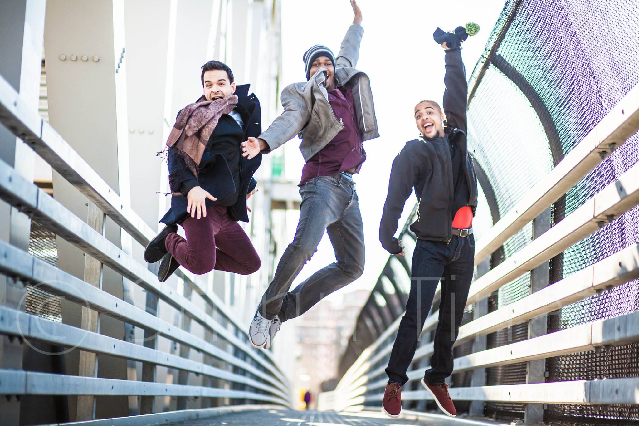 A photograph of Damien on a bridge with three friends, enjoying the day. Photo by Shirin Tinati.