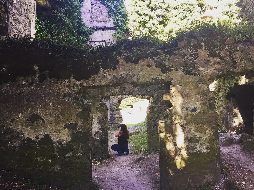 A photograph of the author taking a photograph inside an old castle ruin outside of Menlo, Ireland.