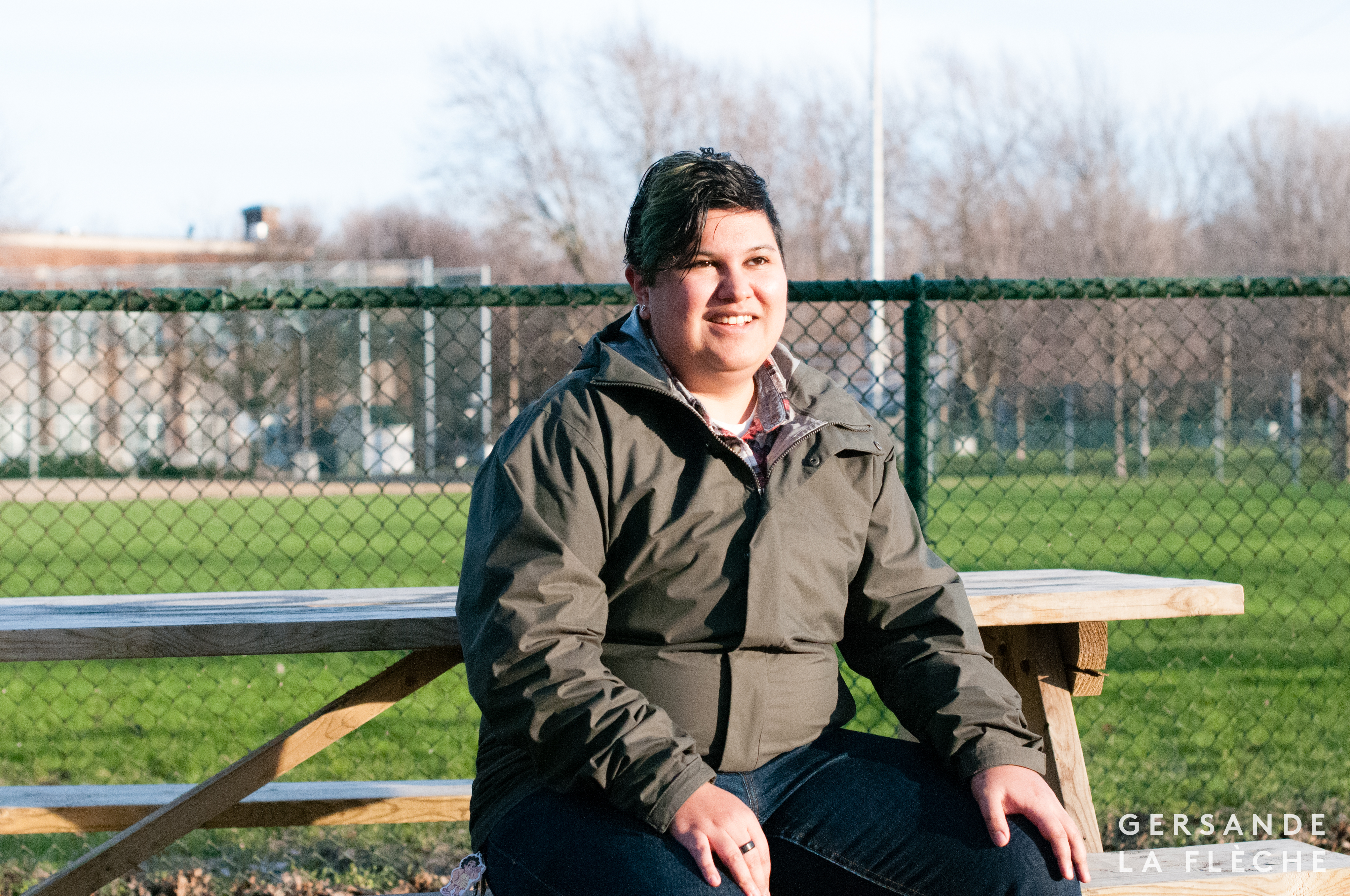 A photo taken by the author of Squinky sitting in the park at sunset.