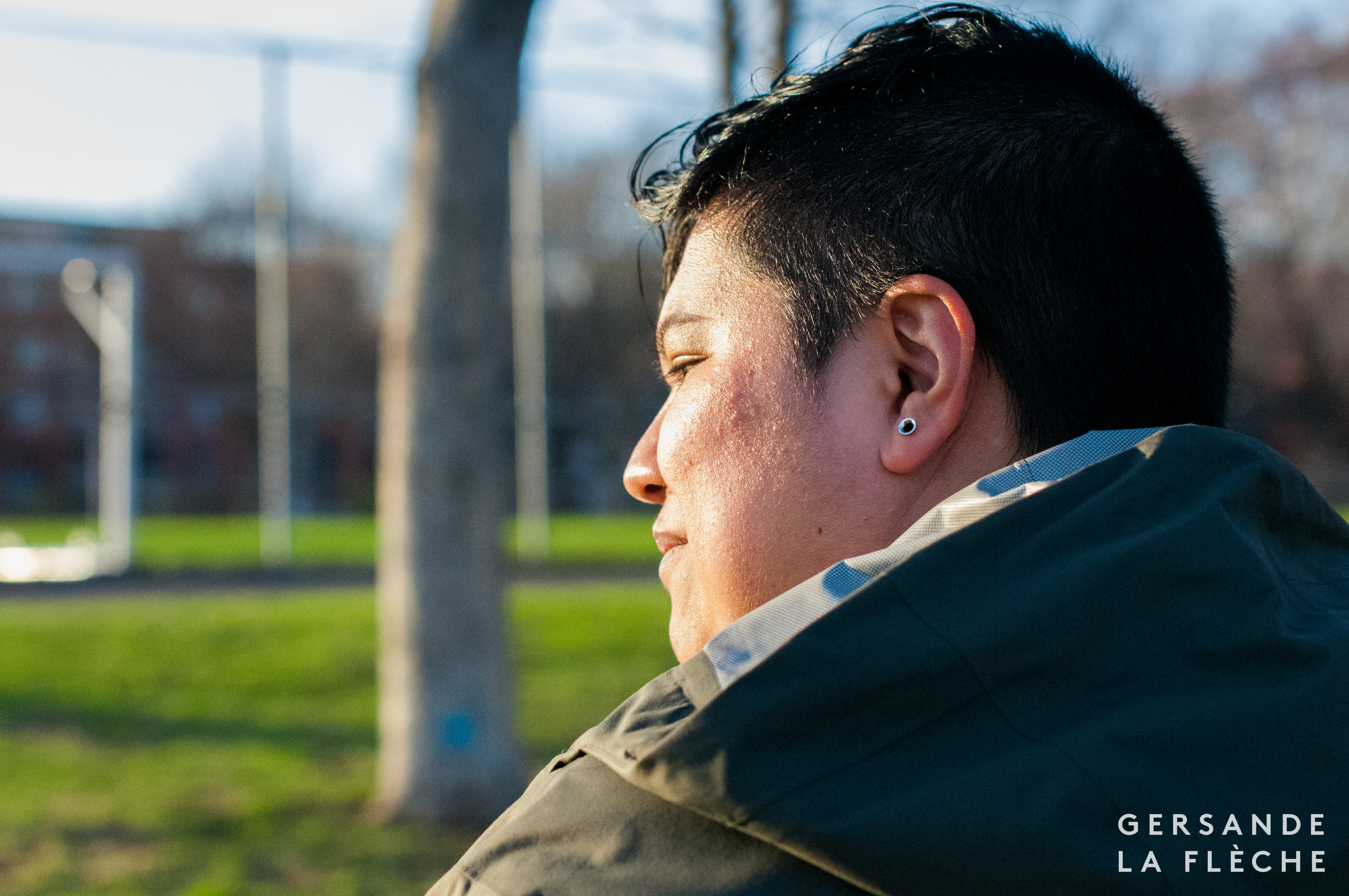 A photo taken by the author of Squinky sitting in the park at sunset.