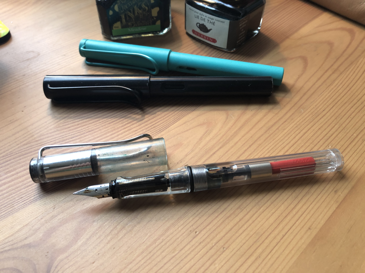 Photo of three Lamy pens, including one made out of transparent plastic so that you can see the insides.