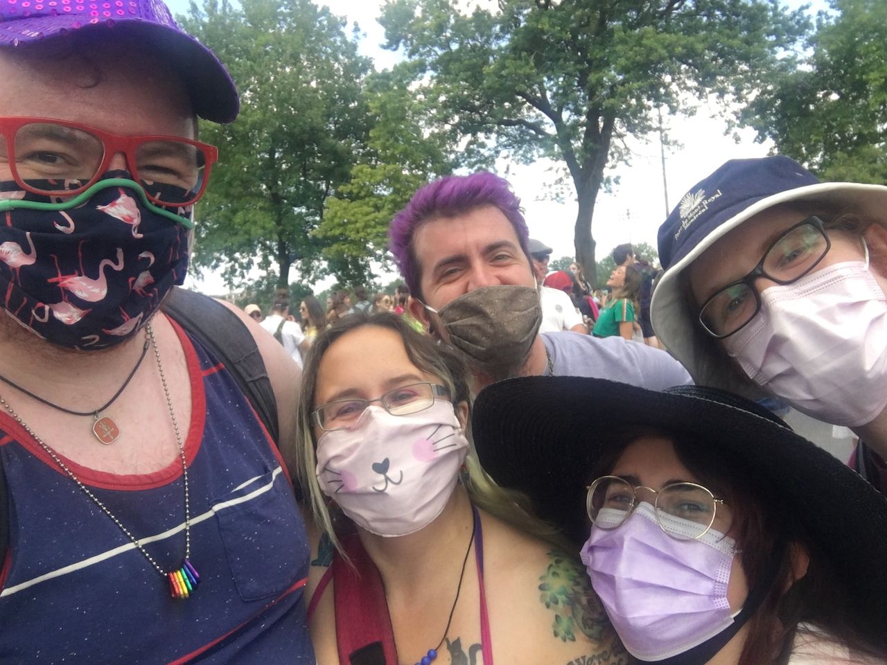 A photo of me and four friends, all masked, waiting for the Pride march to start on Avenue Parc.