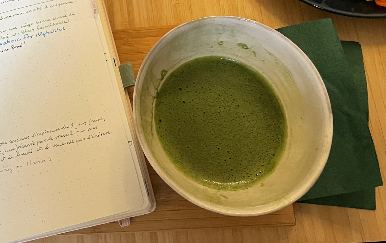 The matcha in the chawan next to my notebook at Cha Do Raku.